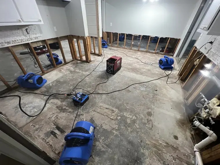 Water damage across a floor after a burst pipe flooded an Oklahoma City home