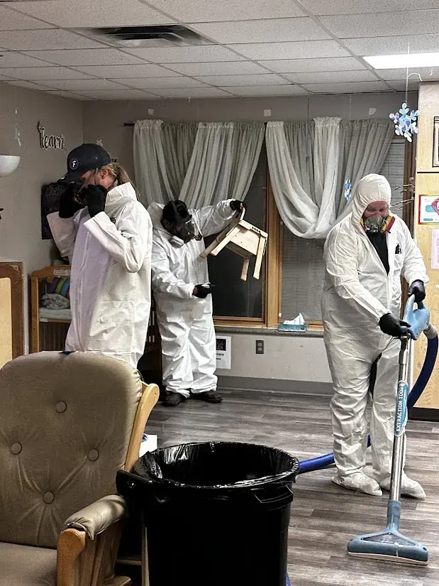 Sewage cleanup crew in protective gear in an Oklahoma City home
